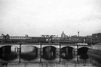 View from ESE showing part of ESE front of Glasgow Bridge with railway bridge in background