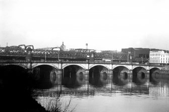 View from SE showing part of ESE front of Glasgow Bridge with railway bridge in background