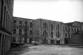 View from SE showing part of E front of mill number 1 with part of mill number 2 on left