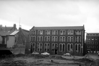 View from E showing ESE front of works with part of mill in background and part of 58 Bishop Street on left