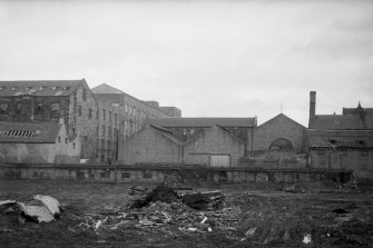 View from W showing WNW front of engineering works with part of foundry on right and mill on left