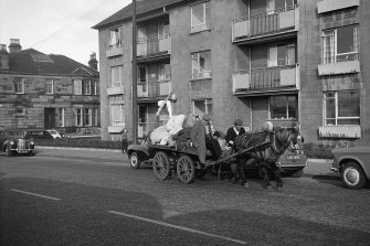 View from WSW showing horse cart passing number 700 Crow Road with number 1 Sackville Avenue in background