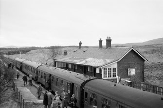 View from W showing WSW and NNW fronts of main station building with train in foreground