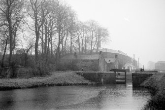 View from NE showing ENE front of lock with depot, cottage and distillery in background