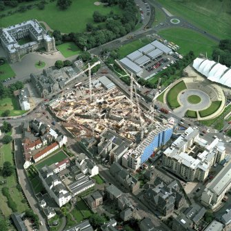 Oblique aerial view of Edinburgh centred on the Parliament site under construction, including Holyrood Palace, Queensberry House and 'Our Dynamic Earth'.