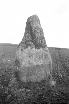 View of standing stone, bearing comb, mirror, and mirror-case symbols.
Original negative captioned: 'Sculptured Stone at Nether Corskie near Waterton of Echt Feb 1914'.
