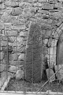 View of Class I Pictish symbol stone and cross-slabs in railed enclosure.
Original negative captioned: 'Sculptured Stone at Old Church of Tullich near Ballater July 1902'.