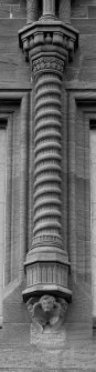 Detail of corbelled-out column above E entrance.