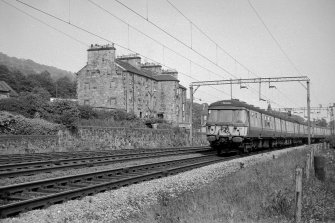 View looking E showing electric train approaching Bowling Station with tenement on left