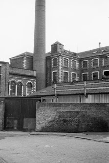 View from N showing part of chimney, main block and other blocks