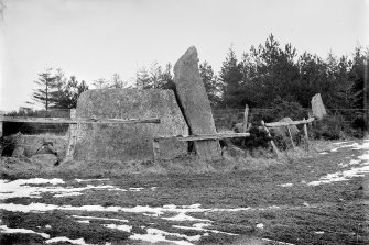 General view from outside the circle.
Glass half-plate negative captioned: 'Stone Circle at Ardoyne from outside of Recumbent Stone March 1904'.
