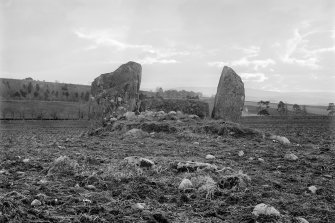 Recumbent stone and flankers from interior of circle.
Negative captioned 'Stone Circle at West Mains, Castle Fraser, near Kemnay. Looking south towards Recumbent Stone 1902'.