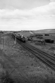 View from W showing train passing site of Robroyston Station
