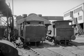 View showing locomotives with buildings in background
