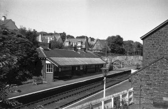 View from SW showing WSW and SSE fronts of up platform building with part of footbridge in background