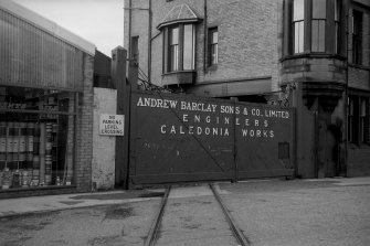 View from E showing NNE front of main entrance gates on West Langlands Street with part of NE block in background