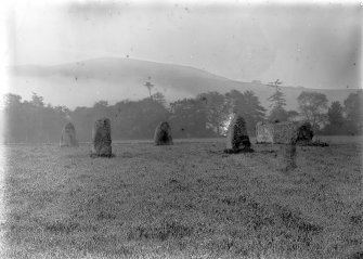 General view of the circle.
Original negative captioned 'Rothiemay Stone Circle from the north'.
Print card captioned 'West side, in early morning, shortly before sunrise, with rising mists.'