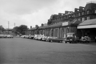 View from NE showing ESE front of S-bound platform building with part of Station Hotel in background