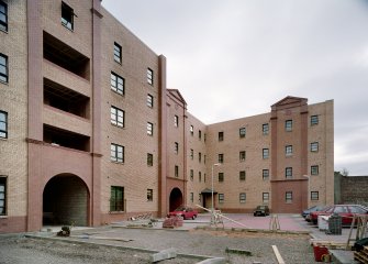 General view from NW of portion of warerhouse comprising 31-5 Trades Lane, reduced in depth, and convered to Scottish Housing Association dwellings (completed in 1995)