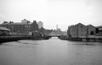 View looking W showing entrance to dock with part of 2-11 Dock Place on left and warehouse on right