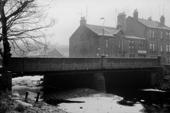 View from SW showing S front of bridge with numbers 31-35 West Shaw Street in background