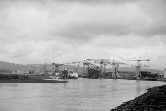 View from S showing John Brown's Shipyard (with QE II on stocks) in distance with part of E bank of Black Cart Water in foreground