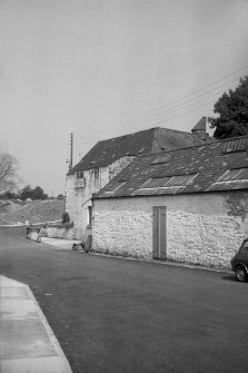 View from SW showing part of WNW front of building with mill in background