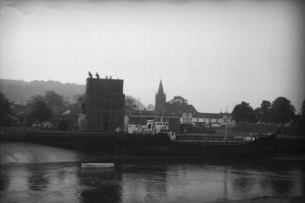 View from NNW showing boat docked at harbour with granary in background