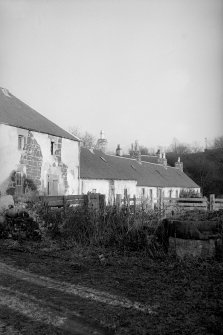 View from SW showing part of SSE front of E cottages with part of W block in foreground