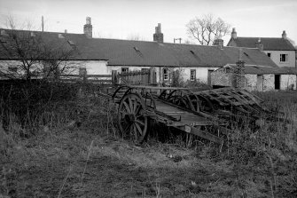 View from S showing farm carts with E cottages in background