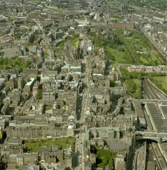 Oblique aerial view of centre of Edinburgh with the High Street running top to bottom across photograph and North and South Bridges running left to right. Digital image of A/40710/CN.