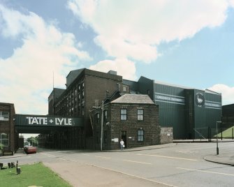 General view from W of W end of works, showing (R to L) East Warehouse (building no. 25, NS2784 7540), Bulk Gran Tanker Loading facility (building no. 23, NS2783 7542), Gatehouse (building no. 4, NS2782 7544), West Gangway (building no. 27, over Drumfrochar Road NS2783 7545), and Filling, Packing & Despatch (building no.30, far left, NS2786 7547)