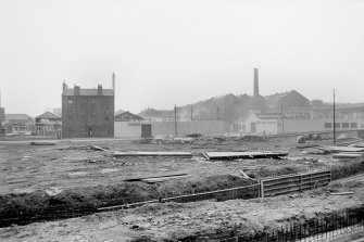 View from NE showing NNE front of tenement with Coop workshops and warehouses in background