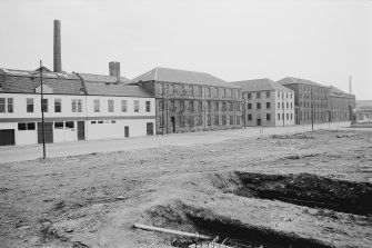 View from N showing WNW front of paint mill with dyeworks and paint factory in foreground and engine works in background