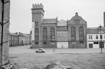 View from W showing WNW front of Victoria grain mills, Glasgow, with part of dyeworks and paint factory on right and school on left in 1968. Watson & Philip Ltd.