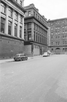 View from S showing ESE front of number 39 with part of numbers 21 in foreground and warehouse in background