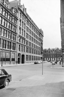 View from N showing WNW front of factory with part of warehouse in foreground and 117 Ingram Street in background