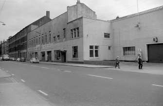 View from W showing NNW front of stables with works in background