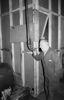 Interior
View showing man speaking into pipe