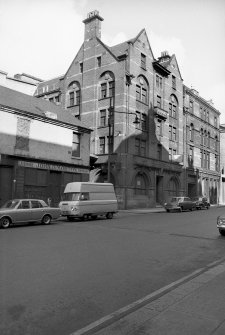 View from SSE showing part of ESE and SSW fronts of warehouse with numbers 23-25 in background and part of numbers 9-15 in foreground