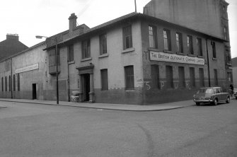 View from ENE showing NNE and ESE fronts of office block with engineering shop in background