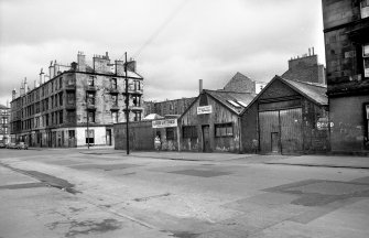 View from SW showing WNW front of stables with tenements in background