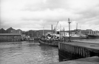 View looking NE showing bulk ore carrier leaving General Terminus Quay with part of S ferry terminus in foreground