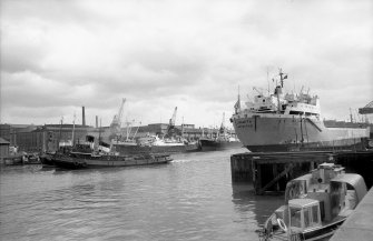 View looking ENE showing bulk ore carrier leaving General Terminus Quay with part of S ferry terminus in foreground