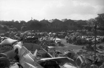 View from NNW showing part of NNW front of works with scrapyard in foreground