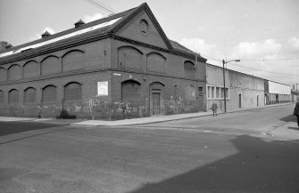 View from SSE showing ESE front and part of SSW front of E block with weaving sheds in background