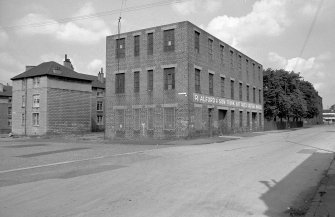 View from SSE showing S and E fronts of factory with part of 109 Reid Street on left