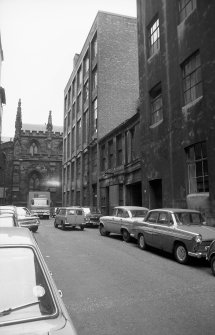 View from NW showing NNE front of building with warehouse in background