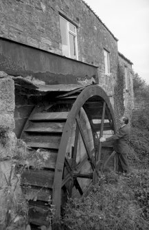 View from SW showing man standing by overshot wheel