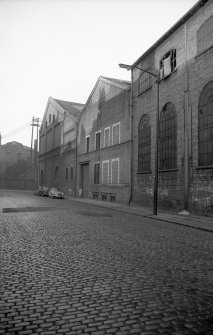 View from SE showing SSW front of warehouse (after it became part of forge) with part of forge on right and left